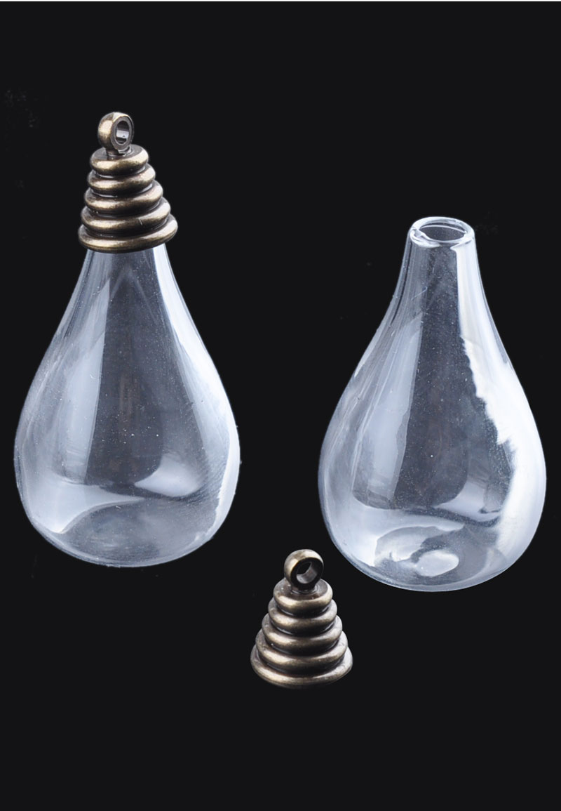 Pendentif/breloque de verre, bouteille avec calottes de métal ± 38x18mm (oeil ± 2mm). Couleur Bronze vieilli Code: D17530 --- Bouteille et calotte metal 38x18. Vx.Bronze---